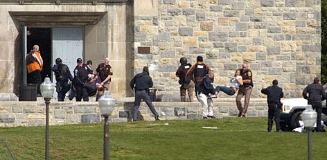 Injured occupants are carried out of Norris Hall at Virginia Tech in Blacksburg, Va., Monday.